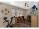 Bedroom featuring exercise equipment, ceiling fan and natural light from three windows at 25438 Pine Valley Dr, Sorrento, FL 32776