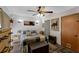 Cozy bedroom with stylish decor, featuring a ceiling fan and comfortable furnishings at 25438 Pine Valley Dr, Sorrento, FL 32776