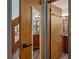 Hallway view leading to a bathroom showcasing vanity with granite counter at 25438 Pine Valley Dr, Sorrento, FL 32776