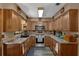 Well-lit kitchen with stainless steel appliances, granite countertops, wood cabinets, and a stainless sink at 25438 Pine Valley Dr, Sorrento, FL 32776