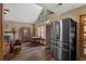 Spacious living room area with fireplace, large windows, hardwood floors, a dining table and stainless refrigerator at 25438 Pine Valley Dr, Sorrento, FL 32776