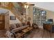 Spacious living room featuring high ceilings, a wall of windows, hardwood floors, and comfortable furnishings at 25438 Pine Valley Dr, Sorrento, FL 32776