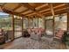 Inviting sunroom featuring a ceiling fan, comfortable seating, and access to the backyard at 25438 Pine Valley Dr, Sorrento, FL 32776