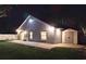 Night view of the backyard with a paver patio, picnic table, storage shed and exterior lighting at 2641 Delcrest Dr, Orlando, FL 32817