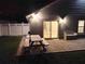 Outdoor patio area with a picnic table, bench seating, and a view of the home's exterior at 2641 Delcrest Dr, Orlando, FL 32817