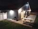 Night view of backyard featuring a brick patio, sliding glass doors, and a picnic table for outdoor enjoyment at 2641 Delcrest Dr, Orlando, FL 32817