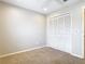 This carpeted bedroom features a closet with shutter style doors and neutral walls at 2641 Delcrest Dr, Orlando, FL 32817