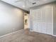 Bedroom featuring wall to wall closet, carpet and doorway to bathroom at 2641 Delcrest Dr, Orlando, FL 32817