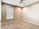 A carpeted bedroom with a ceiling fan and a large window lets in natural light at 2641 Delcrest Dr, Orlando, FL 32817