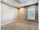 Bedroom with recessed lights, carpet and a window overlooking a yard with greenery at 2641 Delcrest Dr, Orlando, FL 32817