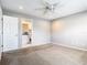 Neutrally decorated bedroom featuring carpet, ceiling fan, and en suite bathroom at 2641 Delcrest Dr, Orlando, FL 32817