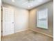Carpeted bedroom includes a ceiling fan, electrical outlets, and bright window at 2641 Delcrest Dr, Orlando, FL 32817