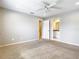 Spacious bedroom with neutral carpet, ceiling fan, and en suite bathroom at 2641 Delcrest Dr, Orlando, FL 32817