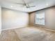Spacious bedroom with neutral carpet, ceiling fan, and window with blinds for natural light at 2641 Delcrest Dr, Orlando, FL 32817