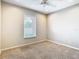 A carpeted bedroom features a large window with bright, natural light at 2641 Delcrest Dr, Orlando, FL 32817