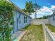 Side yard featuring a blue block wall, white fence, and an area filled with white gravel at 2641 Delcrest Dr, Orlando, FL 32817