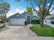 Charming one-story home with a two-car garage, beautiful lawn, and brick-lined driveway at 2641 Delcrest Dr, Orlando, FL 32817