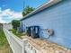 Home exterior featuring a blue wall, white fence, trash cans, and an external hose reel at 2641 Delcrest Dr, Orlando, FL 32817