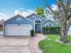 Charming one-story home with a two-car garage, beautiful lawn, and brick-lined driveway at 2641 Delcrest Dr, Orlando, FL 32817
