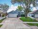 Beautiful one-story home with a two-car garage, landscaped yard, and brick-lined driveway at 2641 Delcrest Dr, Orlando, FL 32817