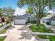 Charming home featuring a well-manicured lawn, a brick-lined driveway, and mature trees at 2641 Delcrest Dr, Orlando, FL 32817