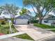 Charming home featuring a well-manicured lawn, a brick-lined driveway, and mature trees at 2641 Delcrest Dr, Orlando, FL 32817