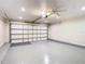 Clean garage featuring painted floor, white walls, and a bright overhead door with opener at 2641 Delcrest Dr, Orlando, FL 32817
