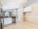 Bright kitchen featuring stainless steel appliances, white cabinets, granite countertops and backyard access at 2641 Delcrest Dr, Orlando, FL 32817