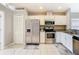 This kitchen offers stainless appliances, white cabinetry, and ample counter space for meal preparation at 2641 Delcrest Dr, Orlando, FL 32817