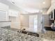 Kitchen featuring granite countertops, stainless steel appliances, and an open view to the living area at 2641 Delcrest Dr, Orlando, FL 32817