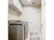 Laundry room featuring a modern washer and dryer, overhead cabinets, and tile flooring at 2641 Delcrest Dr, Orlando, FL 32817