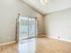 Sunny living room offers vaulted ceiling, ceiling fan, and sliding glass door to brick patio at 2641 Delcrest Dr, Orlando, FL 32817