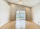 Bright living room boasts vaulted ceiling, fan, wood floors and sliding glass door to backyard at 2641 Delcrest Dr, Orlando, FL 32817