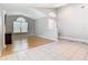 Bright living room featuring hardwood floors, tall ceilings, and large windows, enhancing the sense of space at 2641 Delcrest Dr, Orlando, FL 32817