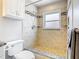 Walk-in shower featuring decorative tiles, built-in shelves, and a shower head at 2641 Delcrest Dr, Orlando, FL 32817
