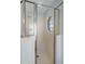 Bright bathroom features a glass-enclosed shower and tiled walls at 26908 Honeymoon Ave, Leesburg, FL 34748