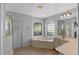Bathroom features a large soaking tub with glass block windows and a separate shower at 26908 Honeymoon Ave, Leesburg, FL 34748