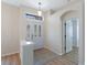 Entryway with tiled flooring, glass front door and natural light, leading to other rooms in the house at 26908 Honeymoon Ave, Leesburg, FL 34748