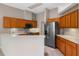 Kitchen with stainless steel appliances, ample wood cabinetry, and bright countertops at 26908 Honeymoon Ave, Leesburg, FL 34748