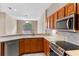 Bright kitchen features stainless steel appliances, light countertops, and wooden cabinets at 26908 Honeymoon Ave, Leesburg, FL 34748