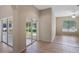 Open-concept living space with sliding glass doors and neutral tile flooring throughout at 26908 Honeymoon Ave, Leesburg, FL 34748
