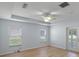 Spacious main bedroom with tray ceiling, fan, and wood-look floors at 26908 Honeymoon Ave, Leesburg, FL 34748