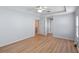 Generous main bedroom features wood-look floors, neutral paint, and ceiling fan at 26908 Honeymoon Ave, Leesburg, FL 34748