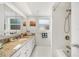 Bright bathroom features a granite countertop, white cabinets, and shower-tub combo at 3024 Saratoga Dr, Orlando, FL 32806