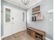 Inviting entryway with a shoe storage bench, coat rack, and decorative details, creating a welcoming ambiance at 3024 Saratoga Dr, Orlando, FL 32806