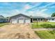 Charming single-story home with a three-car garage and well-manicured lawn at 3024 Saratoga Dr, Orlando, FL 32806