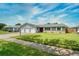 Single-story house with a well-maintained lawn and a three-car garage, featuring a red front door at 3024 Saratoga Dr, Orlando, FL 32806