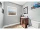 Stylish half-bathroom featuring wood-look flooring, modern sink, and a decorative mirror at 3024 Saratoga Dr, Orlando, FL 32806