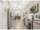 Kitchen featuring stainless steel appliances, granite countertops, and white cabinets, open to dining area at 3024 Saratoga Dr, Orlando, FL 32806