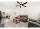 Comfortable living room with gray sofas, textured rug, and views into a dining area at 3024 Saratoga Dr, Orlando, FL 32806